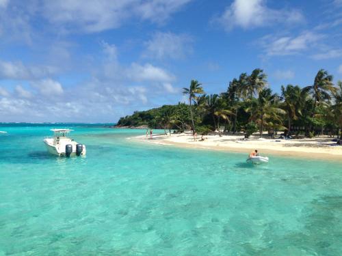 a person in a boat in the water on a beach at Cottage Rodney Bay 2 bedrooms in Gros Islet