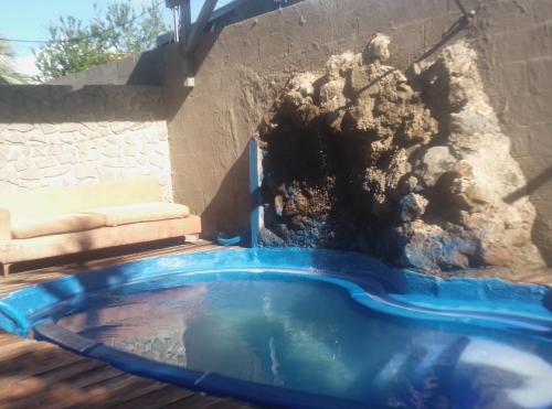 a blue tub filled with sand next to a wall at Villa des Filaos et du lagon o6, 93 , 70 , 59 , 79 in Saint-Leu