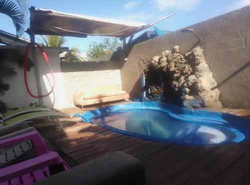 a swimming pool in the middle of a yard at Villa des Filaos et du lagon o6, 93 , 70 , 59 , 79 in Saint-Leu