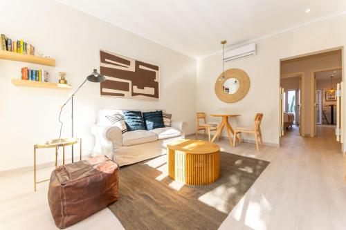a living room with a couch and a table at Casa da Avenida 1 - Centro - Private Terrace in Tavira