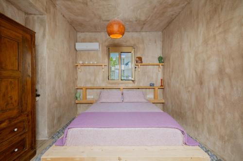 a small room with a bed in the corner at Pefkos Eye in Pefki Rhodes