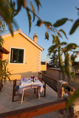 a table sitting on a balcony with at Villa Lora in Tučepi
