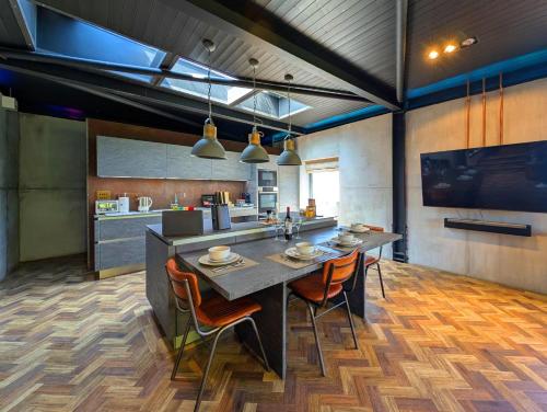 a kitchen with a large table and chairs in a room at The Bells - Luxury Serviced Apartments in Leeds