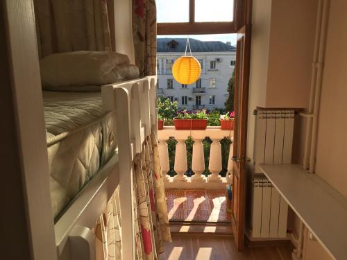 a room with a balcony with a bed and a window at Smile in Sevastopol