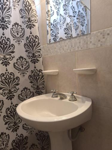 a bathroom with a sink and a mirror at plaza hotel in Termas de Río Hondo