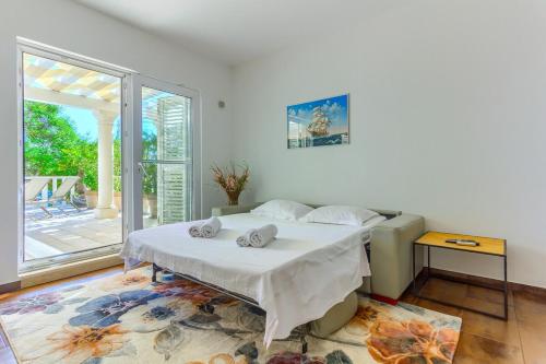 a bedroom with a bed and a large window at Luxury Beach app P2 amazing location in Ivan Dolac