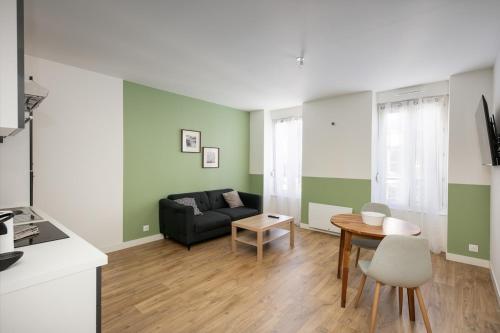 un salon avec un canapé et une table dans l'établissement T2 Kouign Amann, à Brest