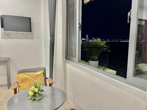 a living room with a table and a window at Seaside Hotel - Rach Gia in Rach Gia