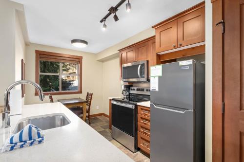 a kitchen with a refrigerator and a stove top oven at Horstman House by Whistler Premier in Whistler