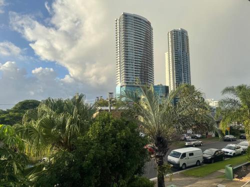 two tall buildings with cars parked in a parking lot at Main Residences Southport in Gold Coast