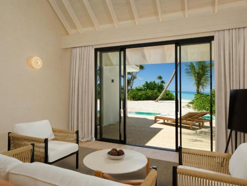 a living room with a view of the beach at Ananea Madivaru Maldives in Toroka