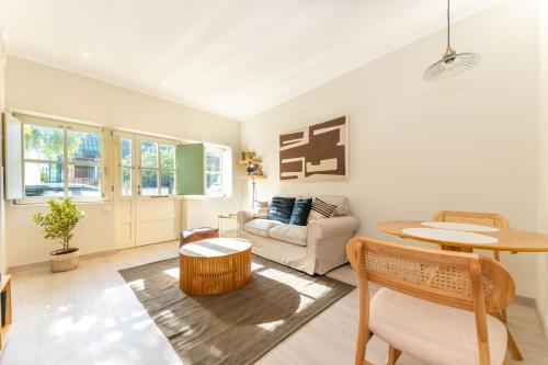 a living room with a couch and a table at Casa da Avenida 1 - Centro - Private Terrace in Tavira