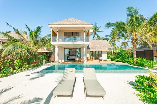 a villa with a swimming pool and a house at Ananea Madivaru Maldives in Toroka