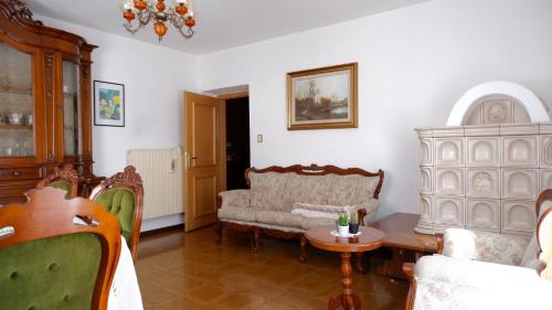 a living room with a couch and a table at Appartamento di Nina in Moena