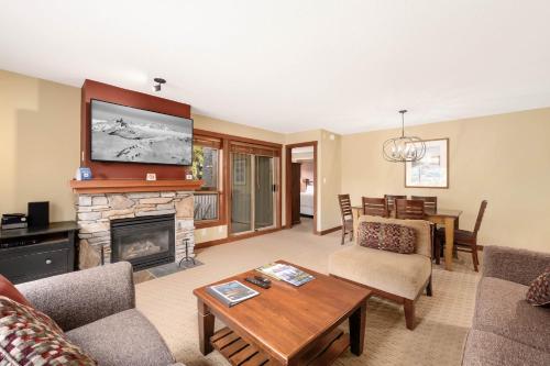 a living room with a fireplace and a tv at Horstman House by Whistler Premier in Whistler