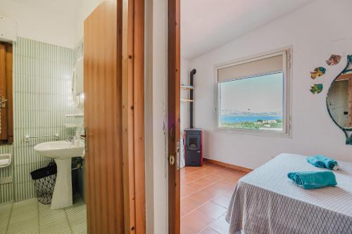 a bathroom with a bed and a sink and a window at Stintino sardegna delizioso bilocale vista mare in Stintino