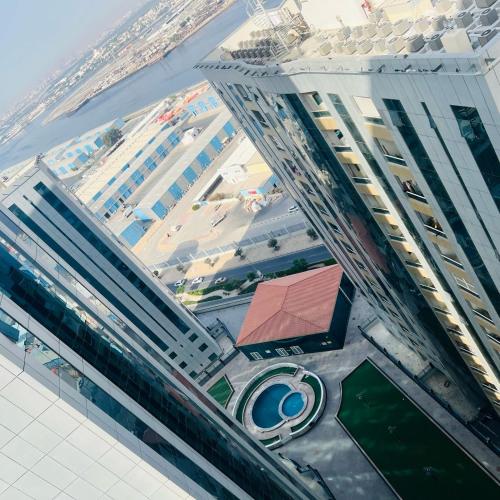 an aerial view of a large building with a pool at orient tower in Ajman 