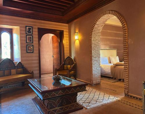 a living room with a room with a bed and a table at Villa Sophia in Azib Oulad Lâdem