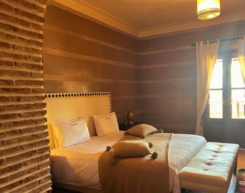 a bedroom with a bed and a window at Villa Sophia in Azib Oulad Lâdem
