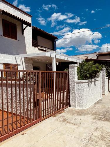 a wooden fence in front of a house at Orione 56 in Rivabella