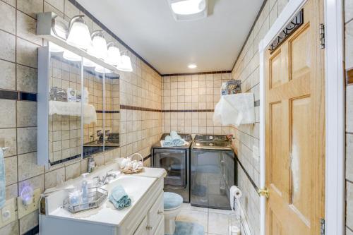a bathroom with a sink and a washing machine at Pet-Friendly Claremont Vacation Rental! in Claremont