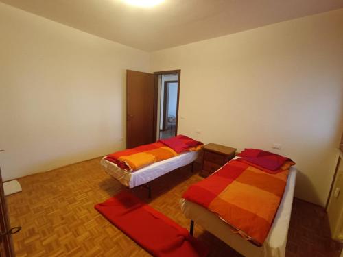 a room with two beds and a window at Appartamento Confine in Concordia Sagittaria
