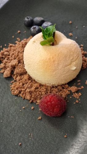 a dessert with a piece of bread and a raspberry and blueberries at Albergo Trieste Boves - Ricetto Suite in Boves