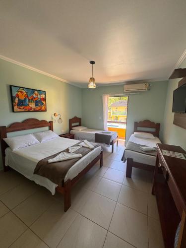 Una cama o camas en una habitación de Pousada Cabeça do Indio - Trindade