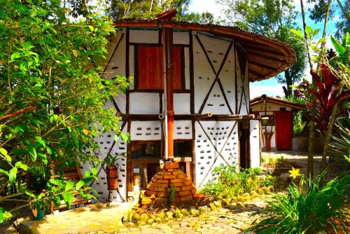 a small house with a fireplace in a garden at Hotel La Casa de Francois in San Agustín