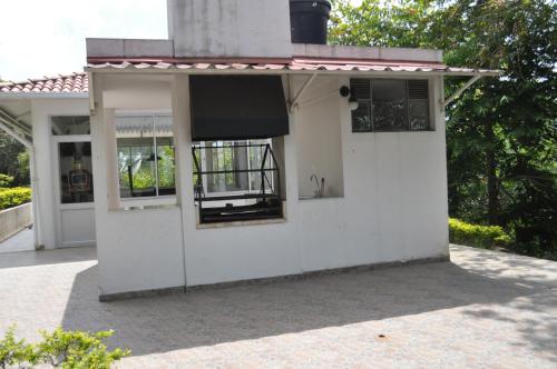 a white house with awning and windows on it at Natural Glamping La Vega in La Vega