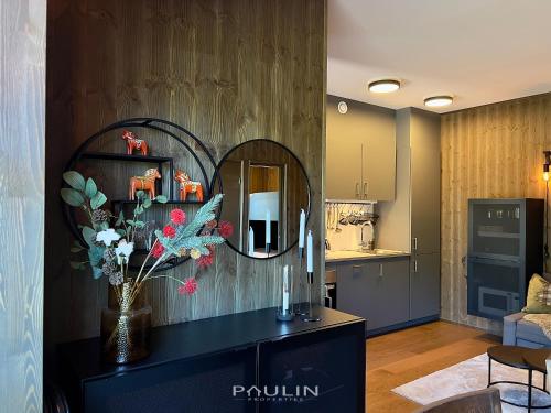 a kitchen with a mirror and a counter with flowers at Lindvallen Ski Resort Pool and Padel - Sauna - 4 Guests in Sälen