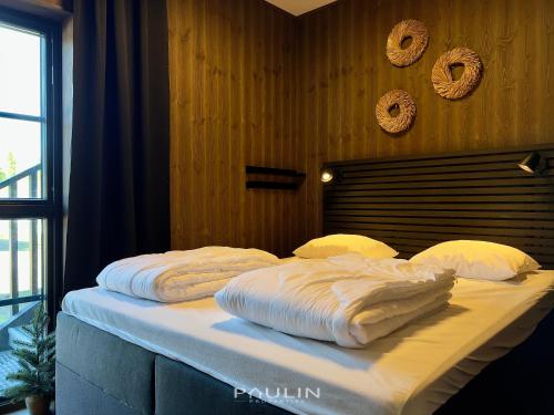 a bed with white sheets and pillows on it at Lindvallen Ski Resort Pool and Padel - Sauna - 4 Guests in Sälen