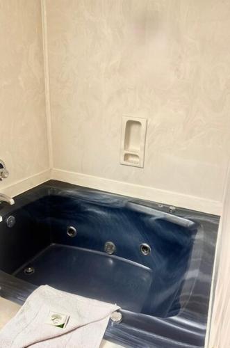 a blue tub in the corner of a bathroom at Boardwalk Beach Resort in Myrtle Beach