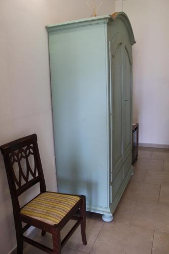 a chair and a cabinet in a room at Tenuta Ferraro Gallipoli in Gallipoli