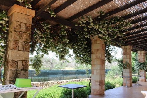 a pergola with a table and a laptop on it at Tenuta Ferraro Gallipoli in Gallipoli