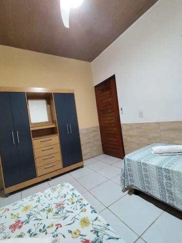 a bedroom with two beds and a dresser at Cantinho da Rosa in Tibau do Sul