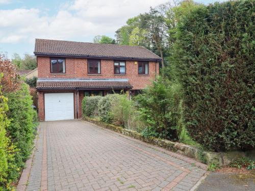 a brick house with a garage and a driveway at Sparrow House in Alnwick