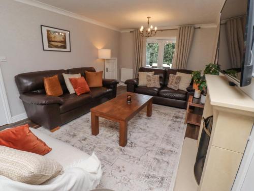 a living room with a couch and a table at Sparrow House in Alnwick
