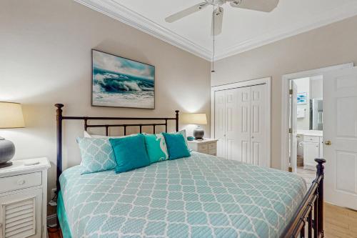 a bedroom with a bed and a ceiling fan at Seaside Sanctuary @ Litchfield by the Sea in Pawleys Island