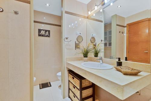 a bathroom with a sink and a shower at Pilar Luxury Apartment in Benalmádena