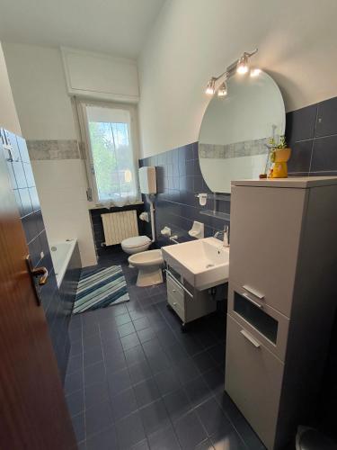 a bathroom with a sink and a toilet and a mirror at Appartamento AZZURRO in Pesaro