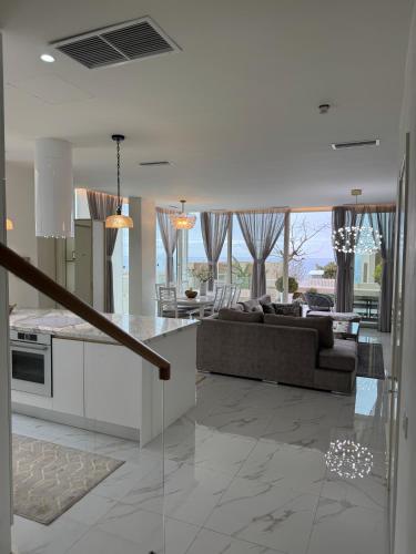 a kitchen and living room with a couch and a table at TIS, Green Coast in Palasë