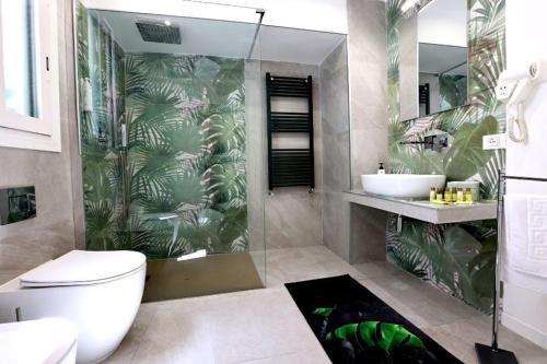 a bathroom with a shower and a toilet and a sink at Ivi's House in Palermo