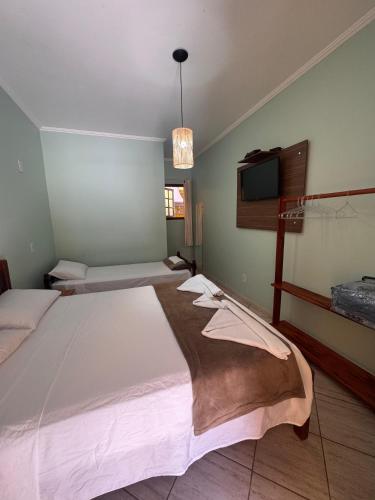 Una cama o camas en una habitación de Pousada Cabeça do Indio - Trindade