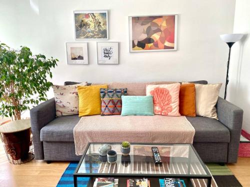 a living room with a couch with colorful pillows at Feel Cascais Center 2bd in Cascais