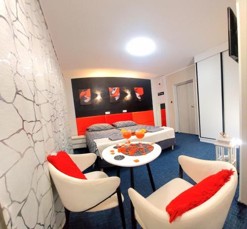a hotel room with a bed and a table and chairs at HORTENSJA 304 in Koszalin