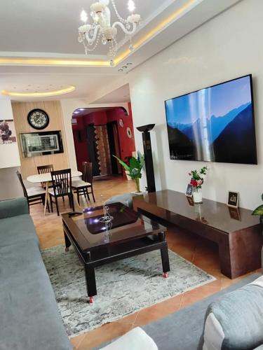 a living room with a couch and a table at Luxury Riad Sidi Bouzid in Moulay Abdallah