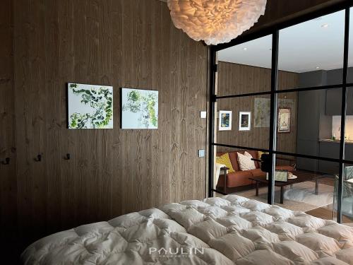 a bedroom with a large bed and a living room at Lindvallen Ski Resort Pool and Padel - Sauna - 4 Guests in Herräng