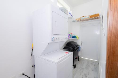 a white laundry room with a washer and dryer at Ka' Romana Residences in El Soco