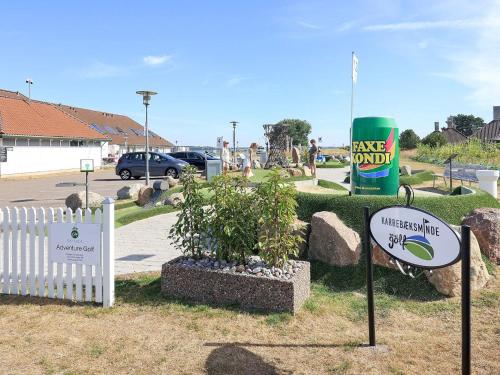 a sign for a park with a potted plant and a playground at 5 person holiday home on a holiday park in Karrebæksminde